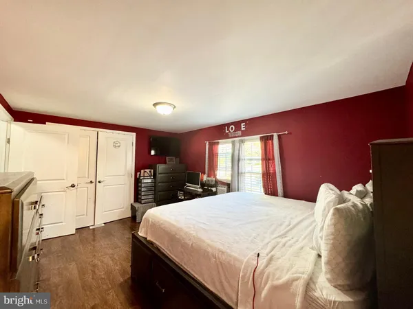 a bedroom with a large bed and a large window