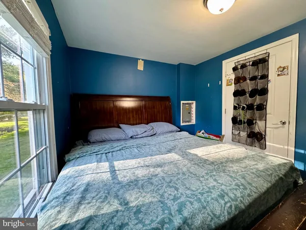 a bedroom with a large bed and a window