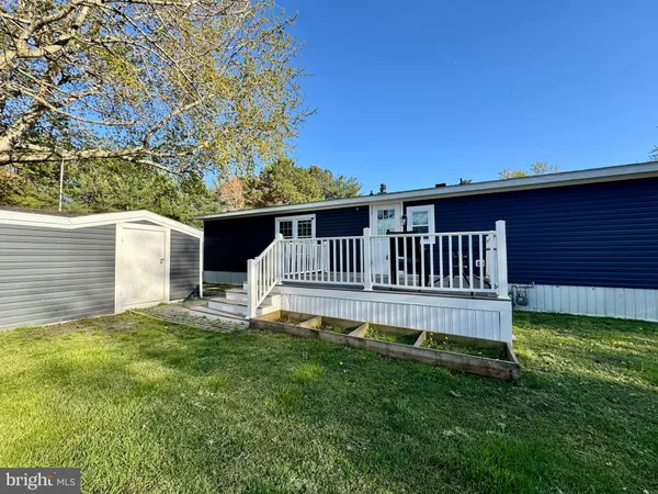 a view of a house with a yard and a porch