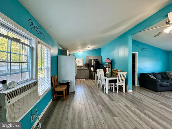 a dining room with furniture and wooden floor