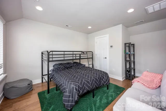 a bedroom with a bed and a couch