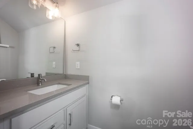 a bathroom with a sink vanity and a mirror