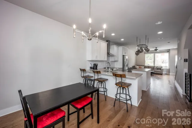 an open kitchen with dining table and chairs