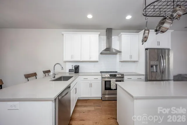 a kitchen that has a sink a stove and a refrigerator