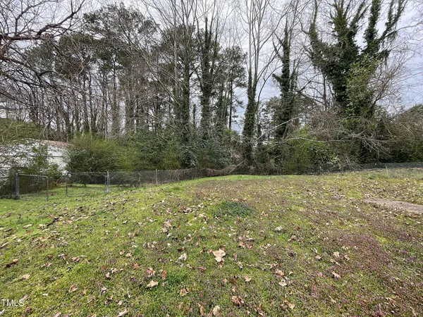 a big yard with lots of green space and trees