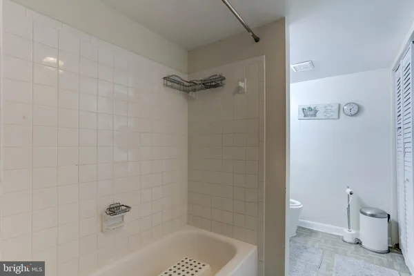 a bedroom with a bed and a night stand