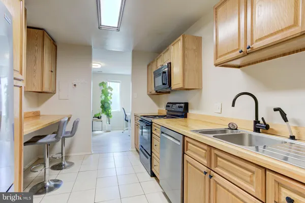 a kitchen with a sink cabinets and appliances