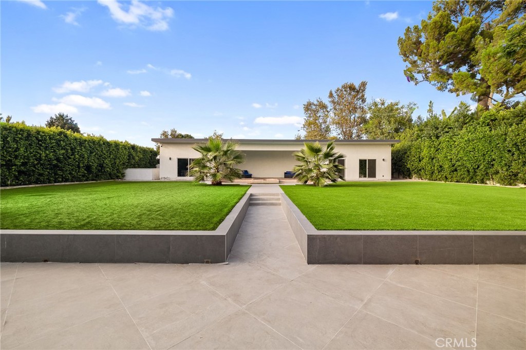 17153 Rayen Street Northridge, CA 91325 - Photo 13 of 75 a view of a garden with a building in the background