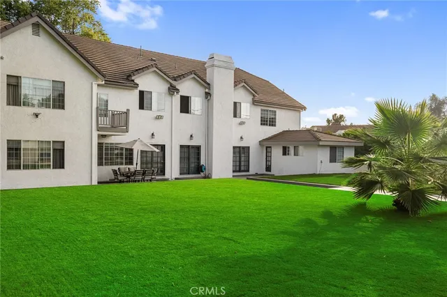 a bathroom with a granite countertop toilet and a sink