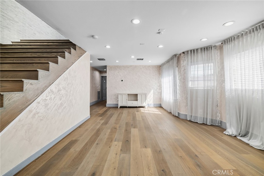 17153 Rayen Street Northridge, CA 91325 - Photo 20 of 75 a view of an empty room with wooden floor and staircase
