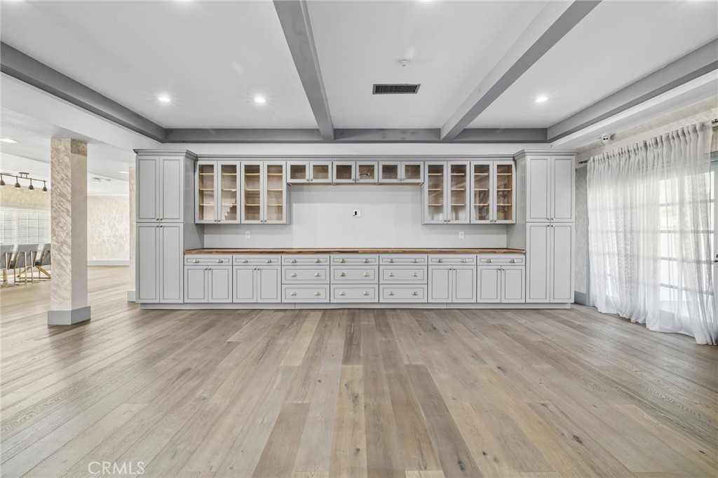 17153 Rayen Street Northridge, CA 91325 - Photo 27 of 75 an empty room with wooden floor and windows