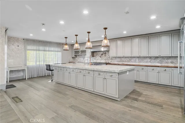 a view of empty room with wooden floor and window