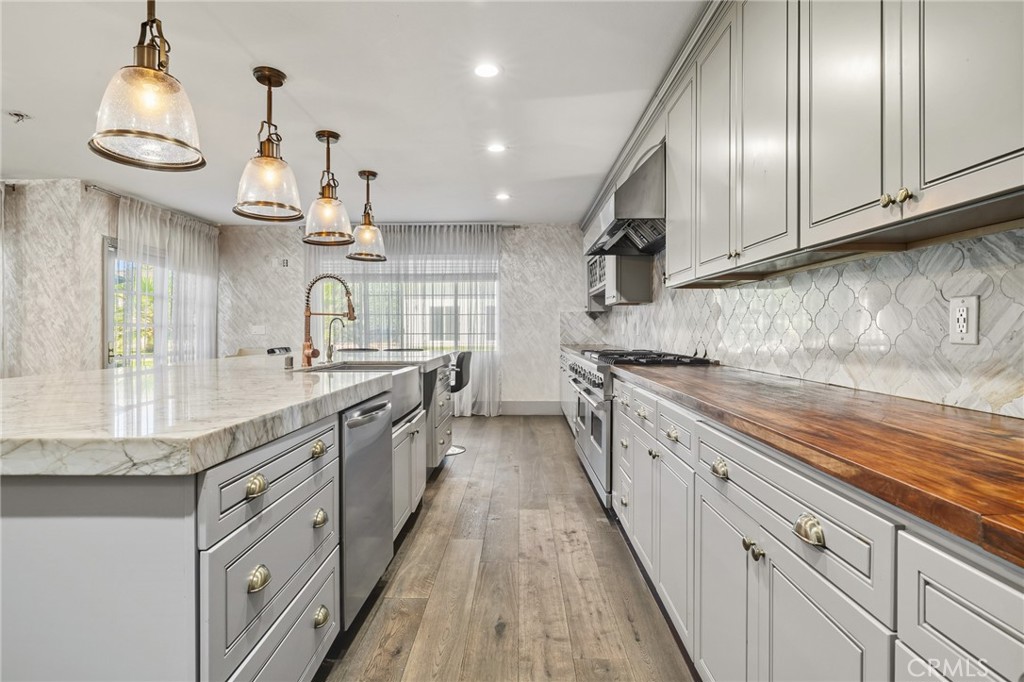 17153 Rayen Street Northridge, CA 91325 - Photo 33 of 75 a large kitchen with granite countertop lots of counter space and a sink