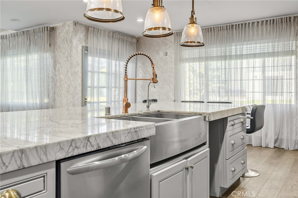 17153 Rayen Street Northridge, CA 91325 - Photo 34 of 75 a kitchen with granite countertop a sink stainless steel appliances and cabinets