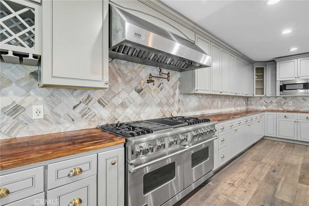 17153 Rayen Street Northridge, CA 91325 - Photo 36 of 75 a white stove top oven sitting inside of a kitchen