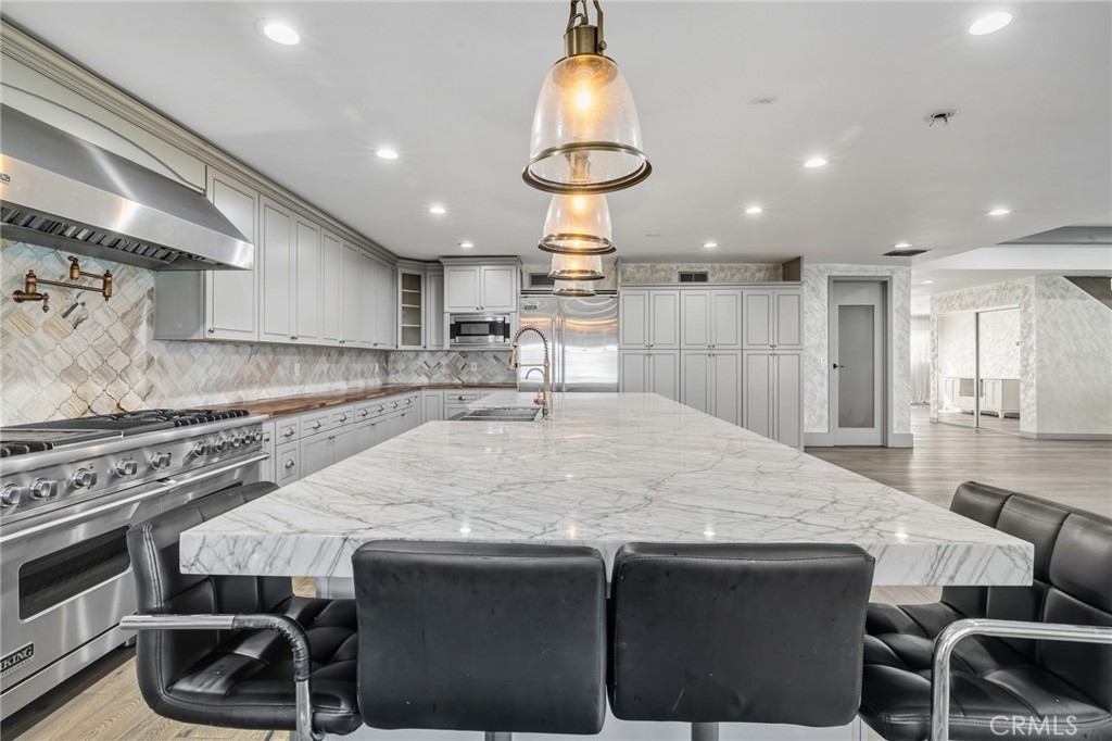 17153 Rayen Street Northridge, CA 91325 - Photo 37 of 75 a kitchen with a table and chairs in it
