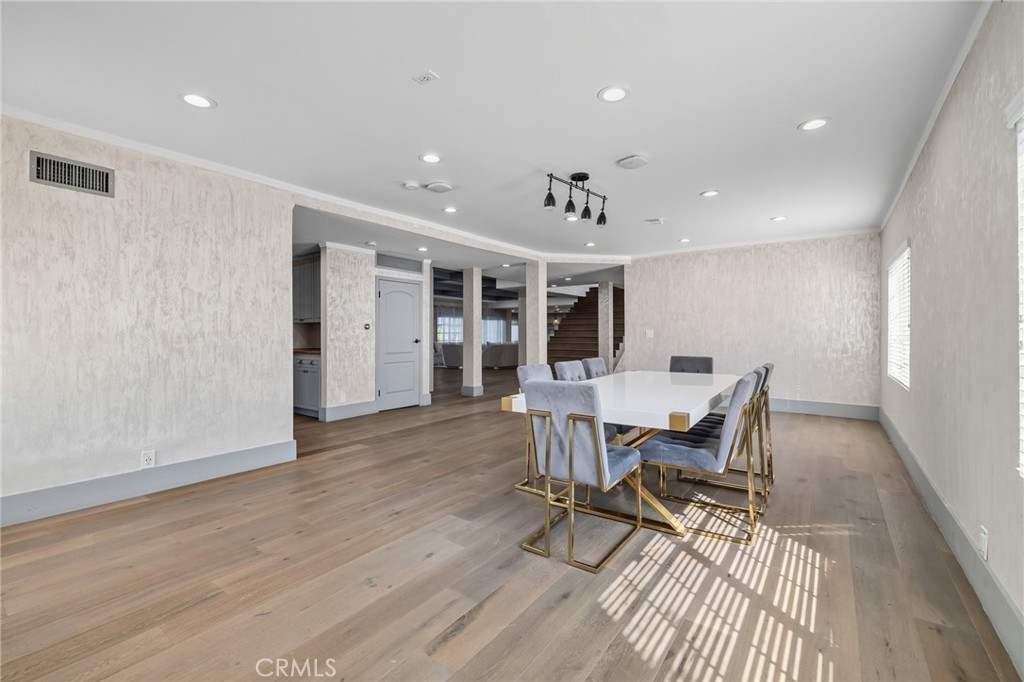 17153 Rayen Street Northridge, CA 91325 - Photo 42 of 75 a view of a dining room with furniture and a wooden floor