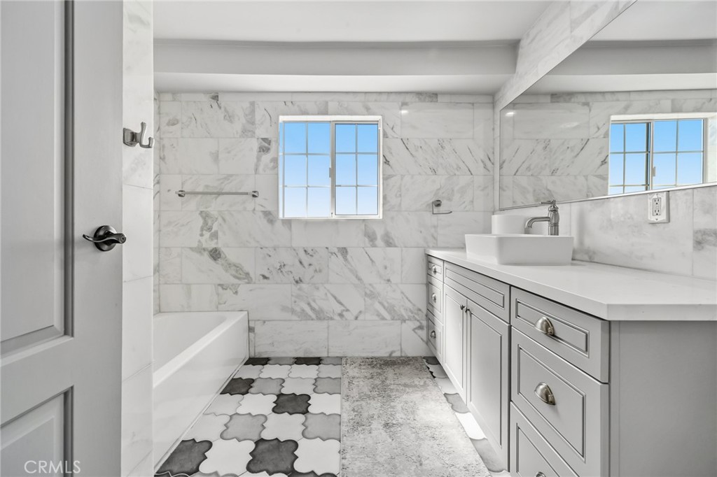 17153 Rayen Street Northridge, CA 91325 - Photo 44 of 75 a bathroom with a granite countertop sink a toilet and shower