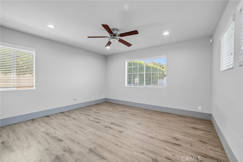 17153 Rayen Street Northridge, CA 91325 - Photo 47 of 75 wooden floor in an empty room with a window