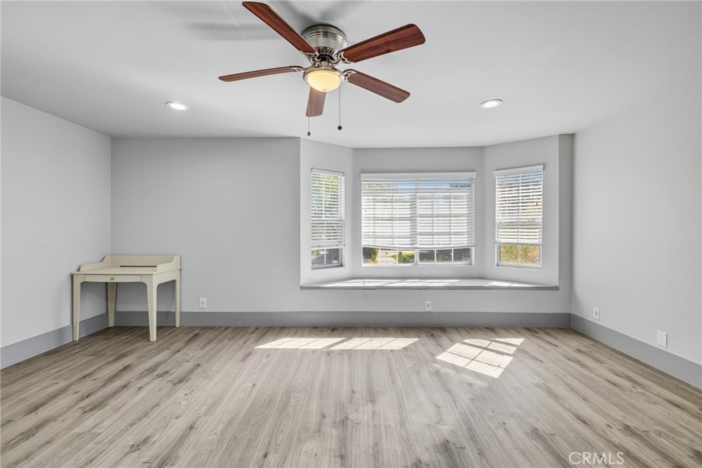 17153 Rayen Street Northridge, CA 91325 - Photo 53 of 75 an empty room with wooden floor and windows