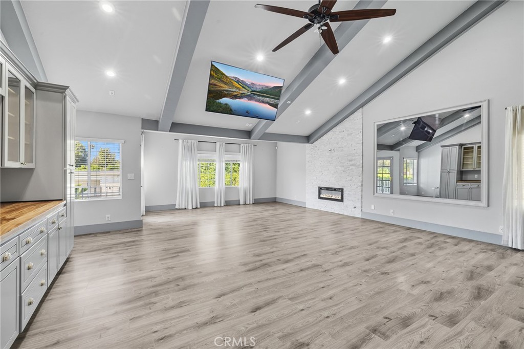 17153 Rayen Street Northridge, CA 91325 - Photo 64 of 75 a view of an empty room with window and wooden floor