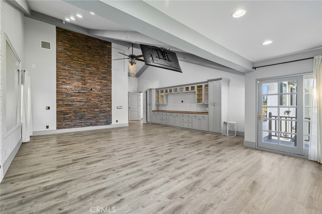 17153 Rayen Street Northridge, CA 91325 - Photo 67 of 75 an empty room with wooden floor and windows