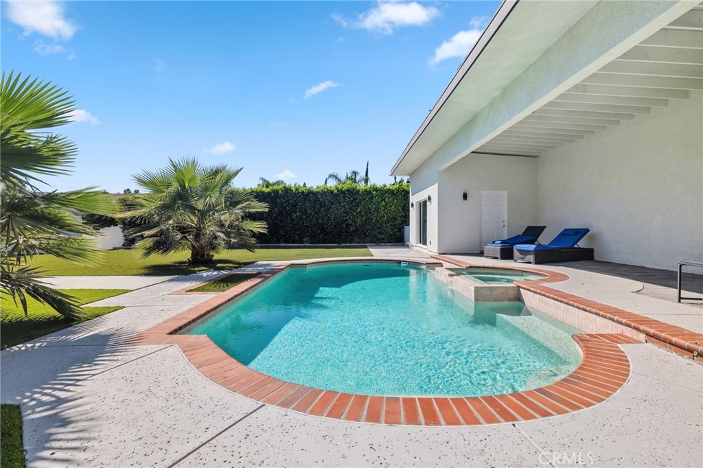17153 Rayen Street Northridge, CA 91325 - Photo 70 of 75 a view of a swimming pool with a lounge chair