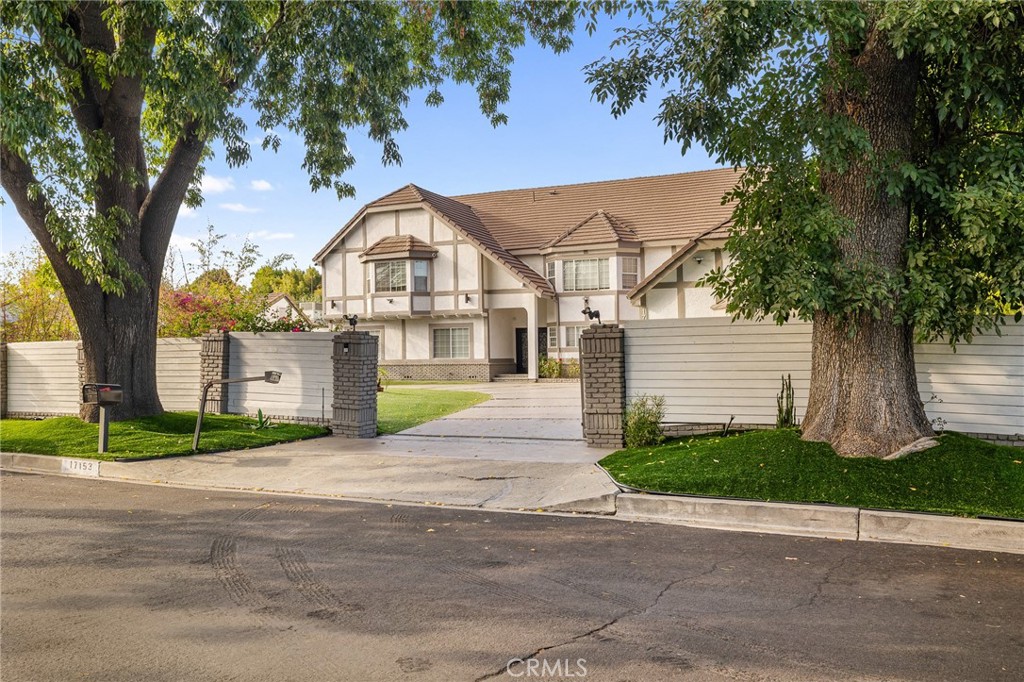 17153 Rayen Street Northridge, CA 91325 - Photo 7 of 75 a front view of a house with a garden and trees