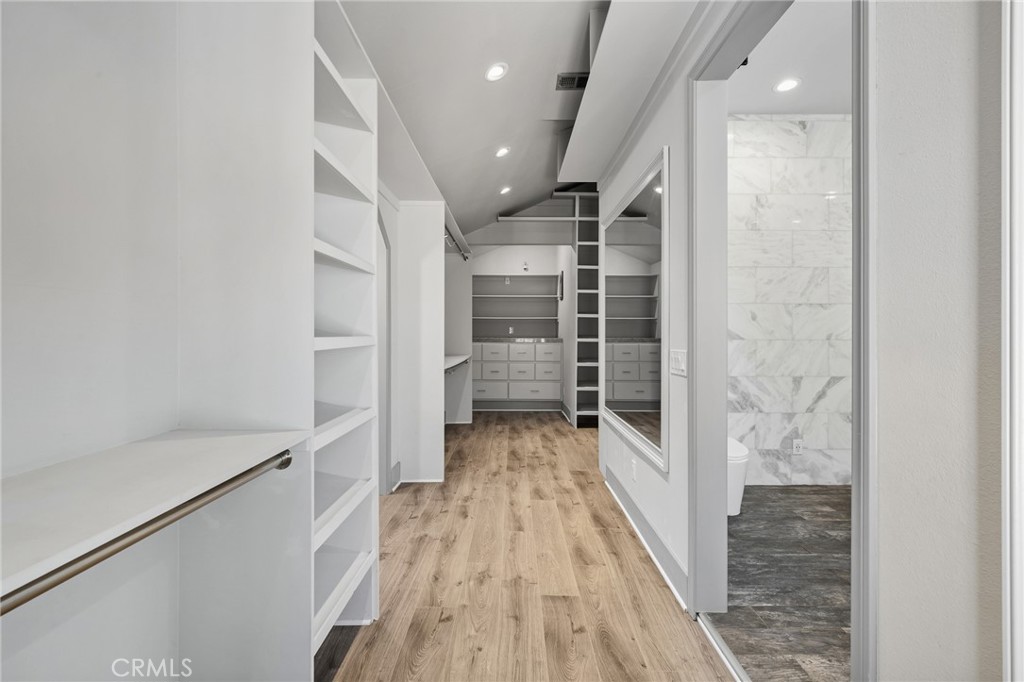 17153 Rayen Street Northridge, CA 91325 - Photo 71 of 75 a view of a hallway with wooden floor and staircase