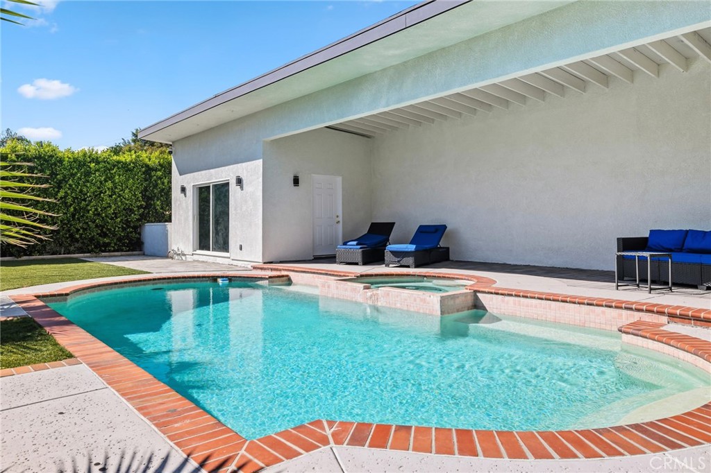 17153 Rayen Street Northridge, CA 91325 - Photo 75 of 75 a view of a swimming pool with a chair and tables