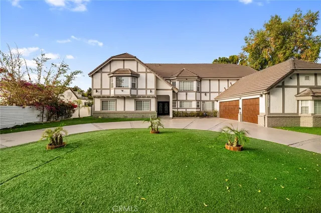 a view of a house with garden and trees