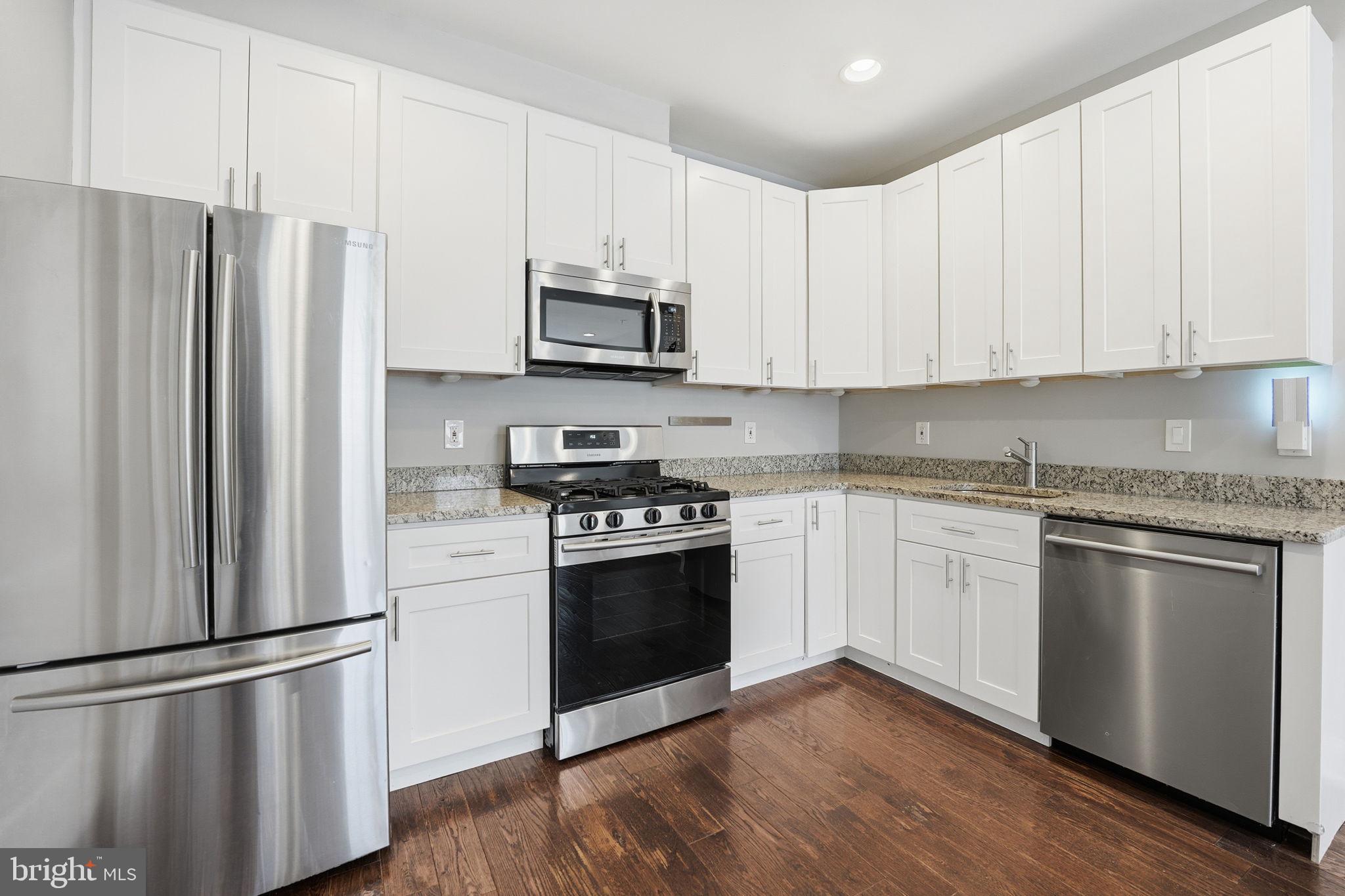 1018 13th Street Southeast, Unit 2 Washington, DC 20003 - Photo 3 of 10 a kitchen with stainless steel appliances and white cabinets