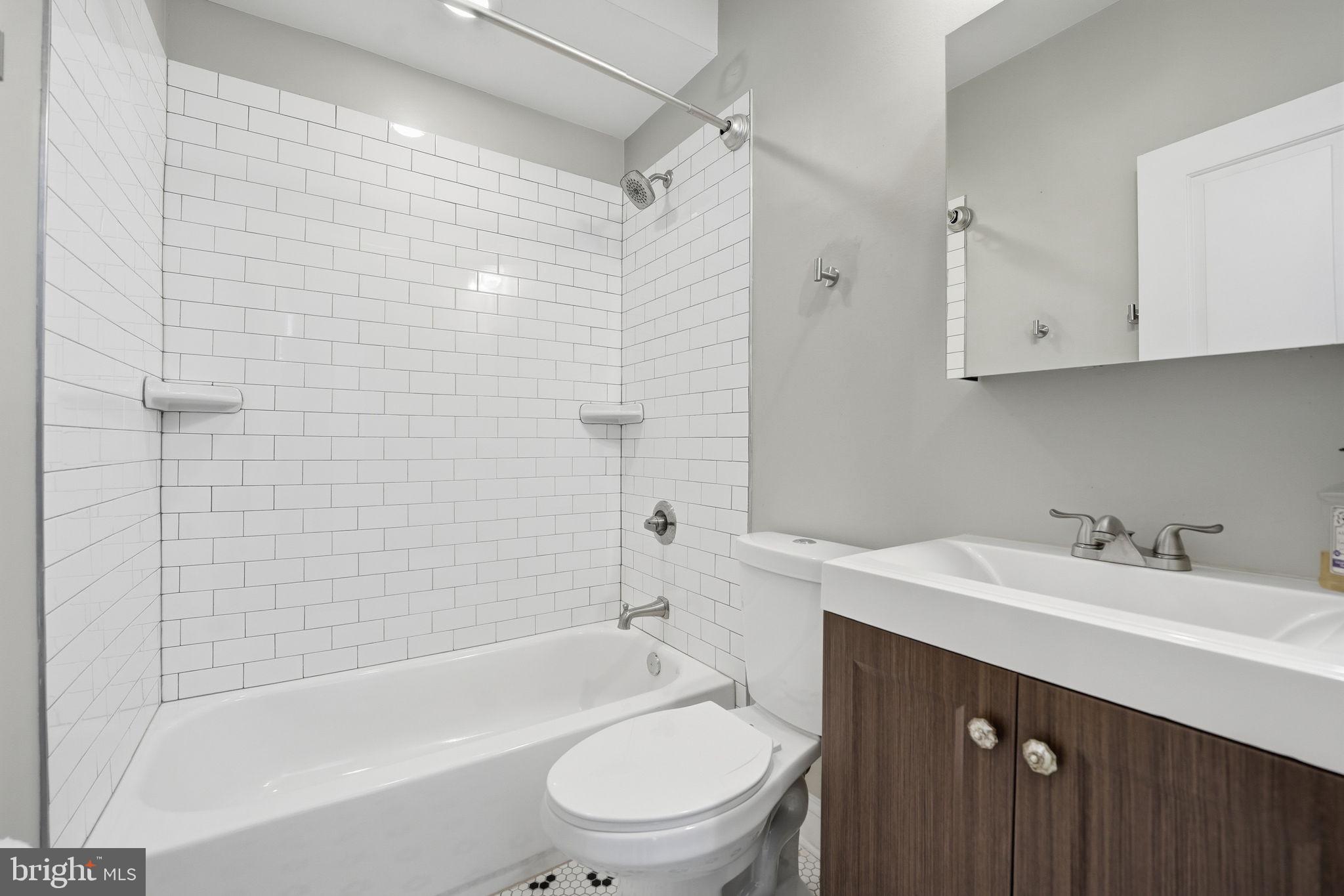 1018 13th Street Southeast, Unit 2 Washington, DC 20003 - Photo 6 of 10 a bathroom with a sink a toilet and shower