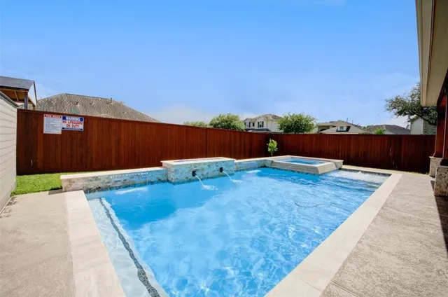 a view of a house with swimming pool and a yard