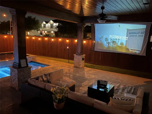 a view of a patio with dining table and chairs with a floor to ceiling window
