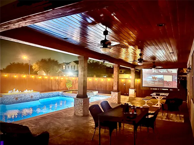 a blue swimming pool with outdoor seating