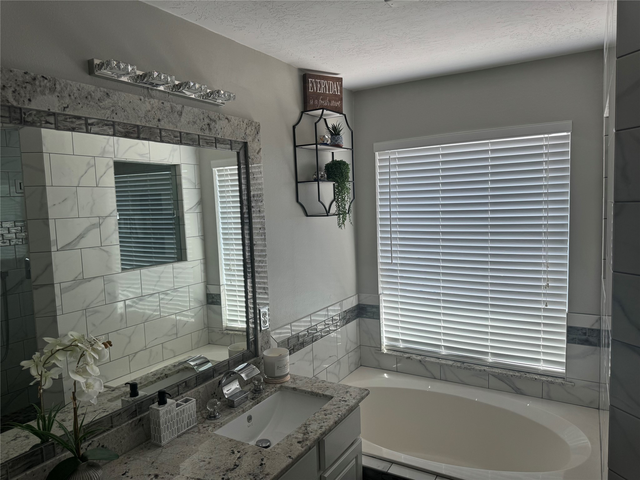 1923 Kaitlyn Drive Houston, TX 77049 - Photo 9 of 22 a bathroom with a granite countertop sink and a bathtub