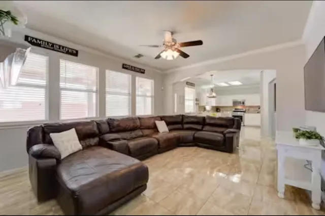 a living room with furniture and a large window