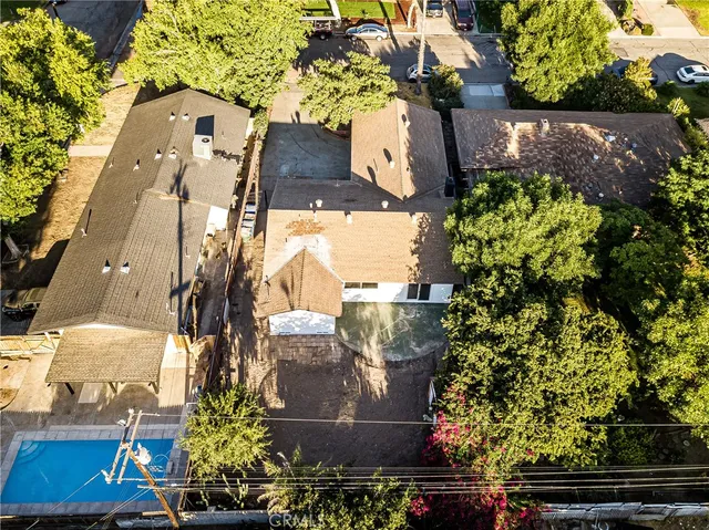 a large white kitchen with kitchen island a sink a refrigerator and a stove top oven