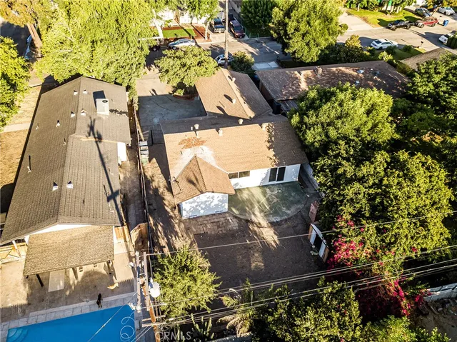 an empty room with wooden floor and a fireplace