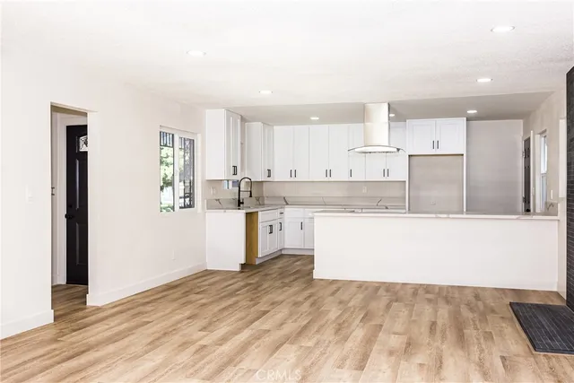 a kitchen with granite countertop white cabinets and stainless steel appliances