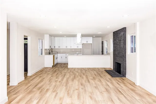 a kitchen with granite countertop a sink and a stove top oven