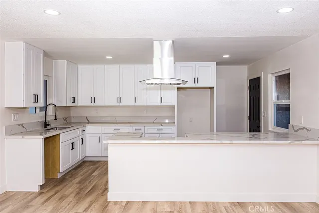 a view of kitchen with sink and refrigerator