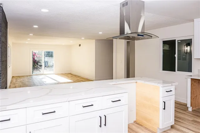 a view of a room with wooden floor and windows