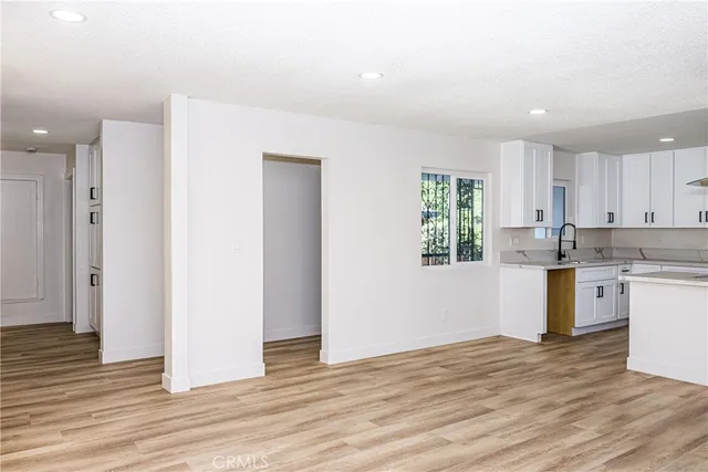 a view of a livingroom with a ceiling fan and wooden floor