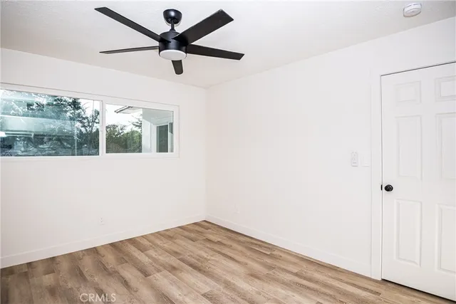a front view of a house with yard and tree