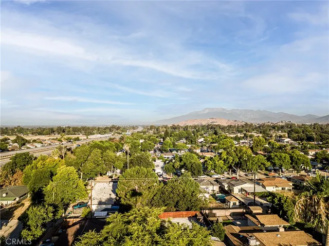 an aerial view of a house with a yard and a large tree