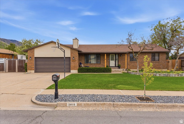2860 East 3575th Street North Layton, UT 84040 - Photo 1 of 1 Single story home with concrete driveway, covered porch, a garage, brick siding, and a gate