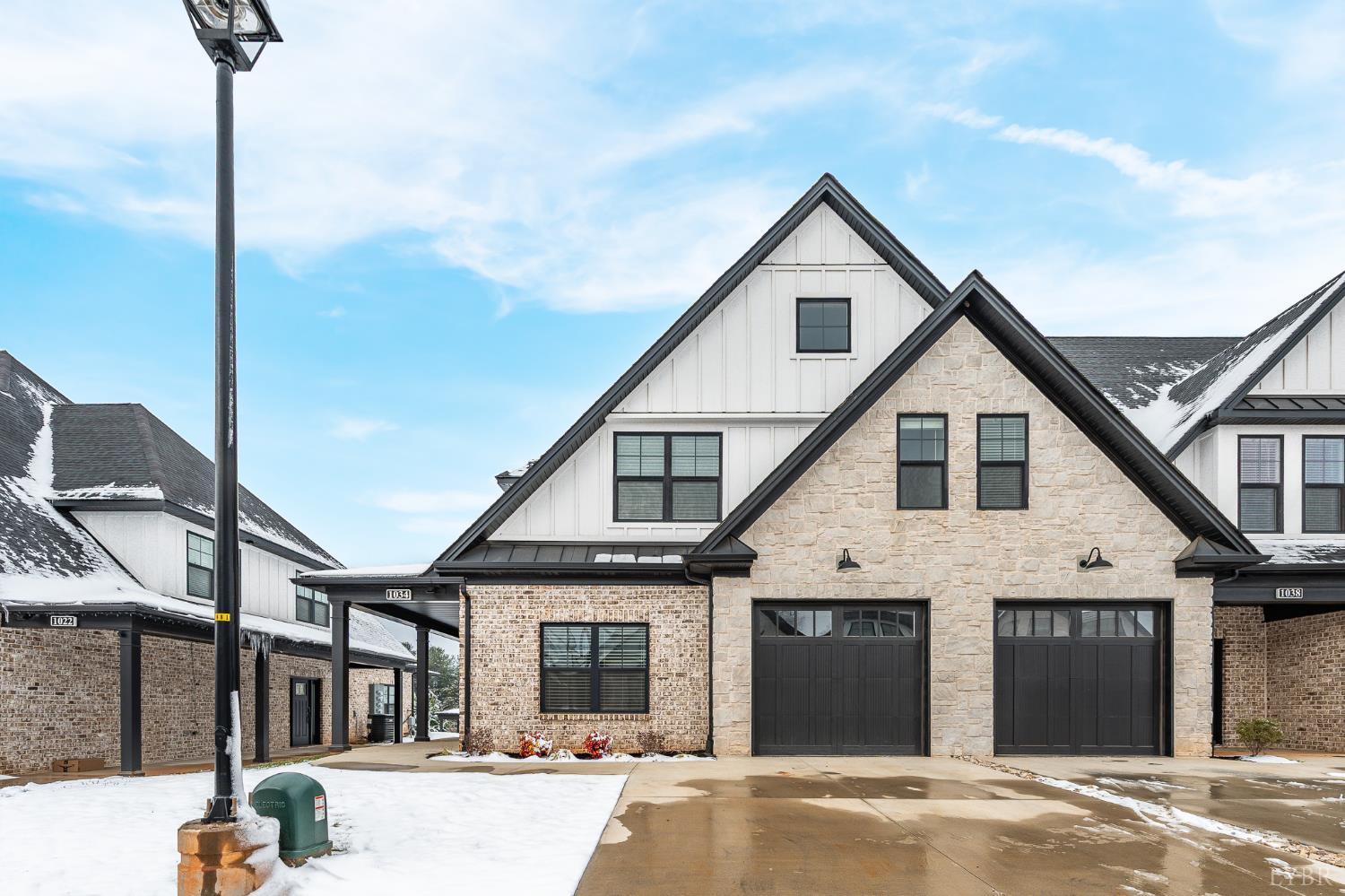 a view of a white house next to a yard