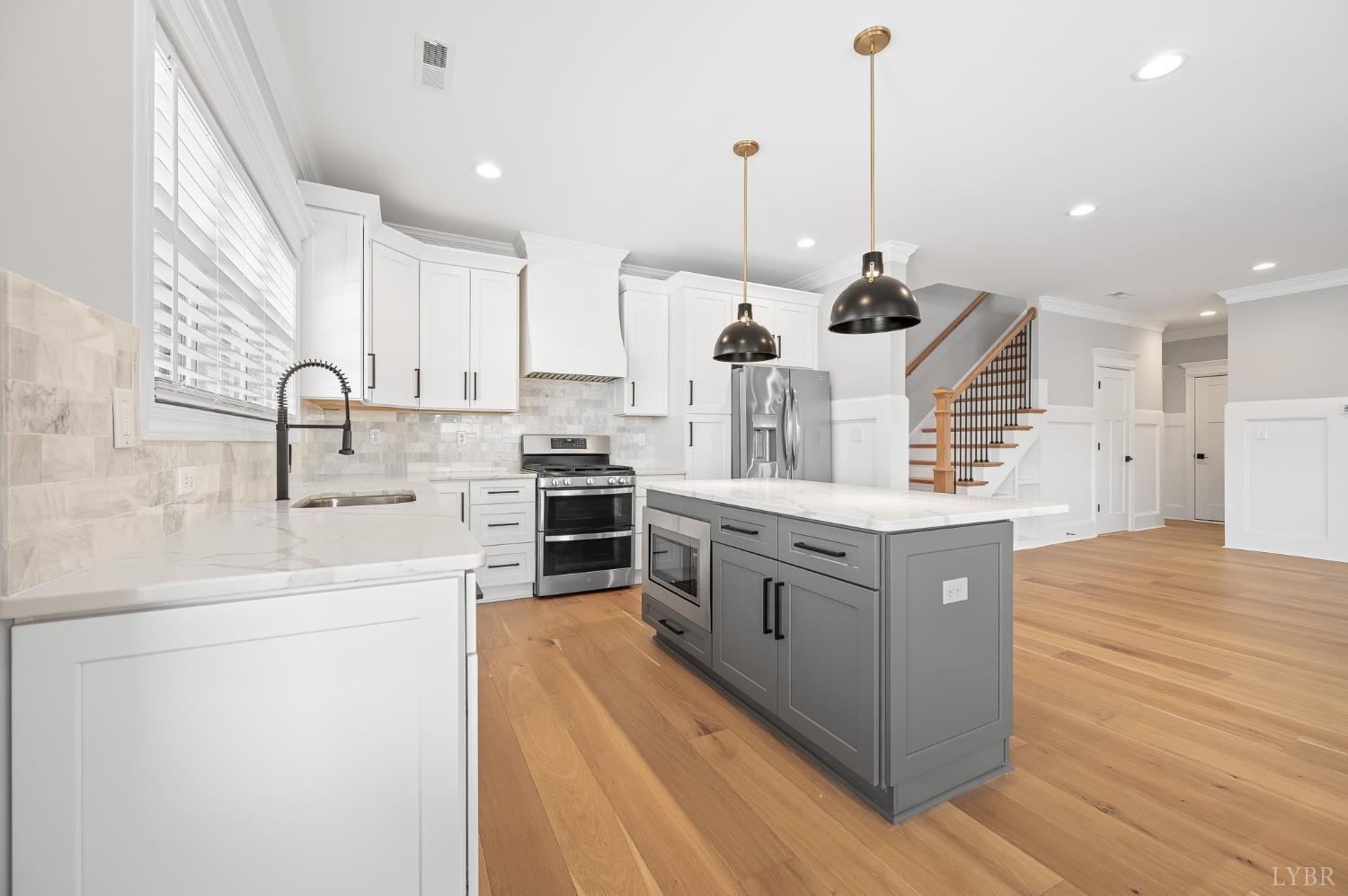 1034 North Westyn Loop Forest, VA 24551 - Photo 14 of 57 a kitchen with stainless steel appliances kitchen island granite countertop a sink a stove and a wooden floors